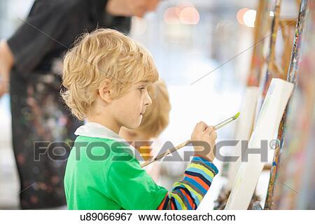 Stock Photo - Boy painting. Fotosearch