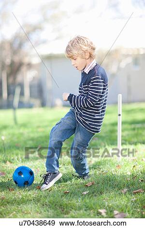 Boy playing football View Large Photo Image Stock Photo - Boy playing football. Fotosearch