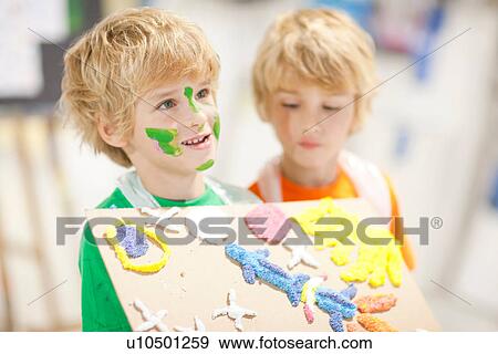 Boy showing his artistic creation View Large Photo Image Stock Photo - Boy showing his artistic creation. Fotosearch
