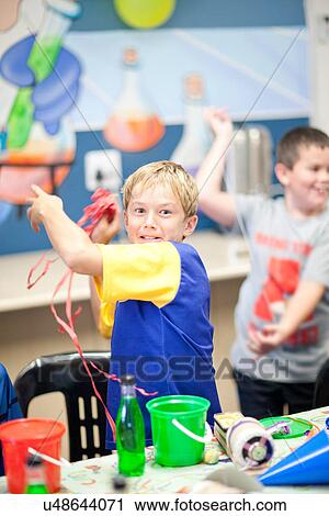 Boy throwing streamers at party View Large Photo Image Stock Image - Boy throwing streamers at party. Fotosearch