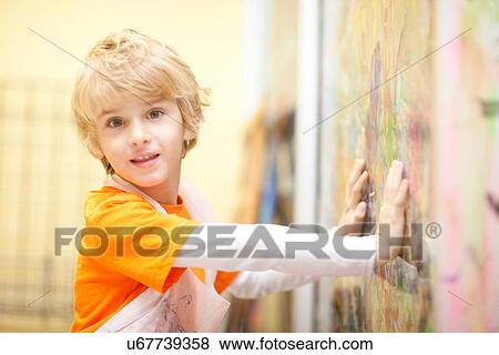 Boy touching painting View Large Photo Image Stock Photo - Boy touching painting. Fotosearch