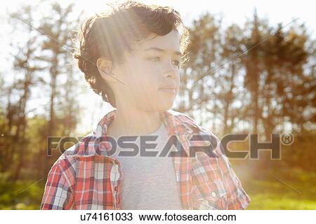 Boy wearing checked shirt in park View Large Photo Image Stock Image - Boy wearing checked shirt in park. Fotosearch