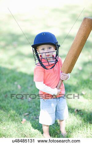 Boy with cricket bat View Large Photo Image Stock Image - Boy with cricket bat. Fotosearch