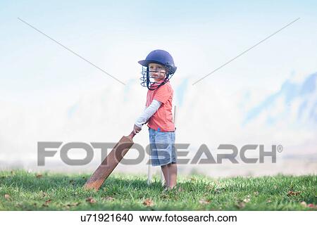 Boy with cricket bat View Large Photo Image Stock Image - Boy with cricket bat. Fotosearch