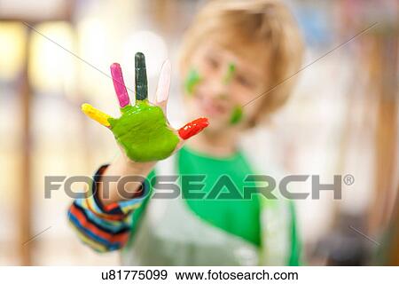 Boy with paint on his hand View Large Photo Image Stock Photo - Boy with paint on his hand. Fotosearch