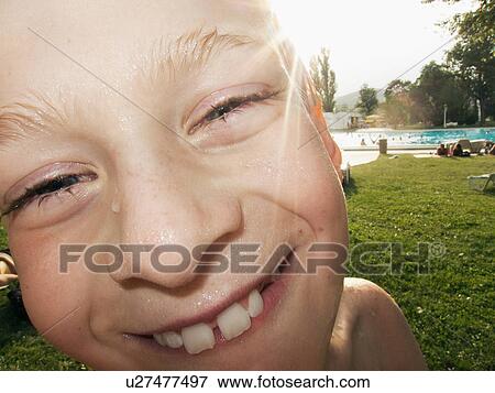 Boy with wet face smiling, portrait View Large Photo Image Stock Photo - Boy with wet face smiling, portrait. Fotosearch