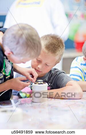 Boys making craft object View Large Photo Image Stock Photo - Boys making craft object. Fotosearch