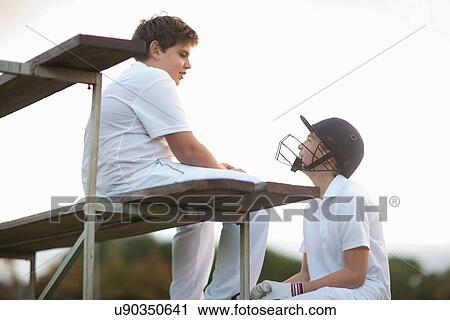 Boys on bleachers at cricket pitch View Large Photo Image Stock Image - Boys on bleachers at cricket pitch. Fotosearch
