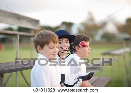 Boys on bleachers at cricket pitch View Large Photo Image Stock Photo - Boys on bleachers at cricket pitch. Fotosearch