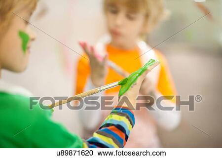 Stock Image - Boys painting their hands. Fotosearch
