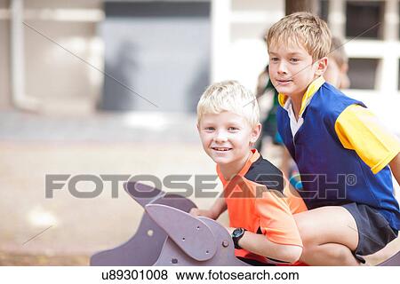 Stock Photo - Boys playing in park. Fotosearch