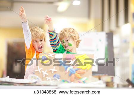 Boys showing their artistic creation with arms raised View Large Photo Image Stock Photo - Boys showing their artistic creation with arms raised. Fotosearch