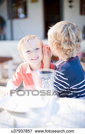 Stock Photo - Boys whispering. Fotosearch