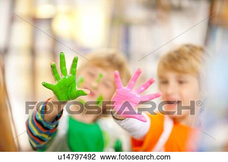 Stock Image - Boys with paint on their hands. Fotosearch