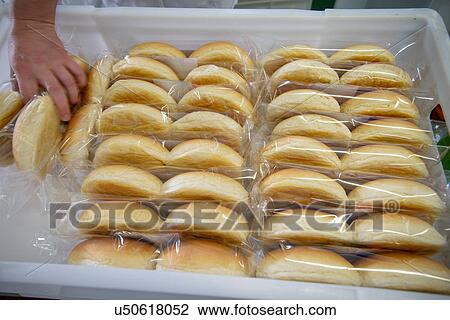 Stock Image - Bread rolls packed and arranged in box. Fotosearch