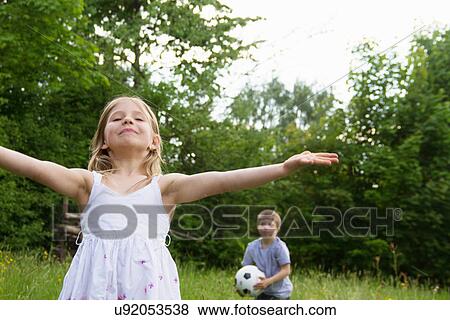 Brother and sister playing outdoors View Large Photo Image Stock Photo - Brother and sister playing outdoors. Fotosearch