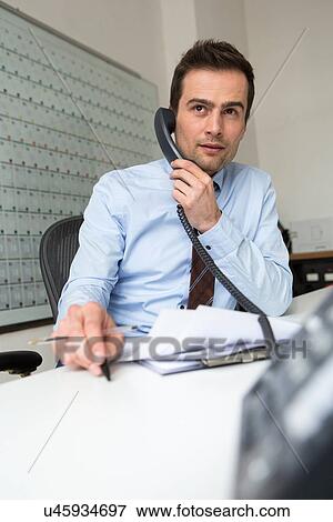 Businessman multitasking, telephone call and administration View Large Photo Image Stock Photo - Businessman multitasking, telephone call and administration. Fotosearch