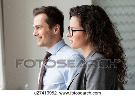 Businesspeople looking through window View Large Photo Image Stock Image - Businesspeople looking through window. Fotosearch