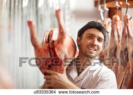 Butcher holding carcass over shoulder View Large Photo Image Picture - Butcher holding carcass over shoulder. Fotosearch