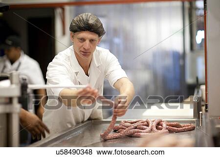 Butcher making sausages View Large Photo Image Stock Photo - Butcher making sausages. Fotosearch