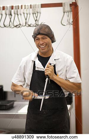 Stock Photo - Butcher sharpening knife. Fotosearch