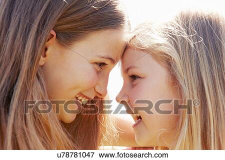 Stock Photo - Children touching foreheads. Fotosearch
