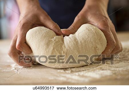 Close up of hands kneading bread dough View Large Photo Image Stock Photo - Close up of hands kneading bread dough. Fotosearch