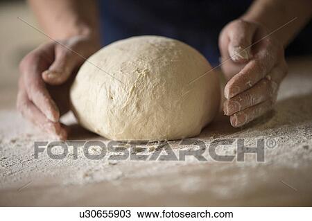 Close up of hands shaping bread dough View Large Photo Image Stock Image - Close up of hands shaping bread dough. Fotosearch