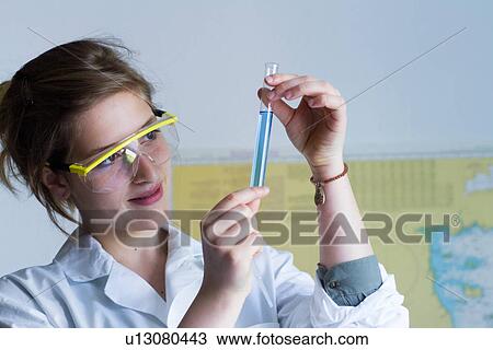 Close up of teenage girl examining test tube View Large Photo Image Stock Image - Close up of teenage girl examining test tube. Fotosearch