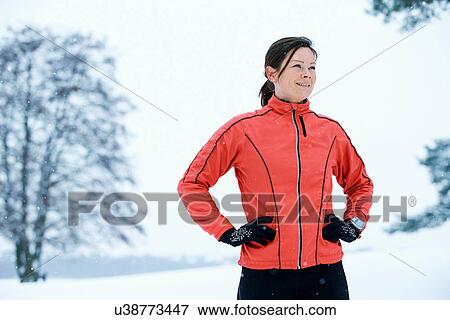 Close up of woman standing in snow field View Large Photo Image Stock Photo - Close up of woman standing in snow field. Fotosearch