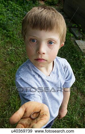 Close up portrait of boy with a worm in his hand View Large Photo Image Stock Photo - Close up portrait of boy with a worm in his hand. Fotosearch