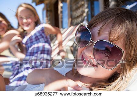 Stock Photo - Close up portrait of girl wearing sunglasses. Fotosearch