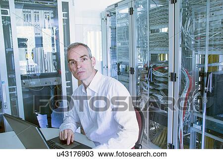 Computer technician working on server View Large Photo Image Stock Image - Computer technician working on server. Fotosearch