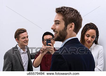 Picture - Creative team taking each others portrait. Fotosearch