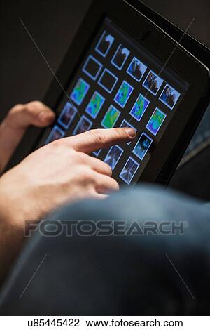 Cropped composition of teenage boy's hand using digital tablet View Large Photo Image Stock Image - Cropped composition of teenage boy's hand using digital tablet. Fotosearch