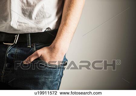 Stock Image - Cropped shot of hand inside pocket of jeans. Fotosearch