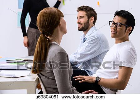 Stock Image - Design team discussing ideas. Fotosearch