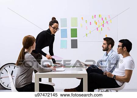 Design team sitting at table discussing ideas View Large Photo Image Stock Photography - Design team sitting at table discussing ideas. Fotosearch