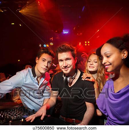 Disc Jockey surrounded by group of people View Large Photo Image Stock Image - Disc Jockey surrounded by group of people. Fotosearch