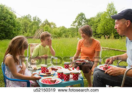 Family with two children enjoying birthday picnic View Large Photo Image Stock Photo - Family with two children enjoying birthday picnic. Fotosearch