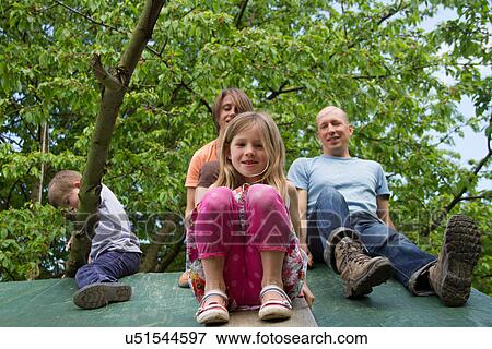 Family with two children sitting on playhouse roof View Large Photo Image Stock Photo - Family with two children sitting on playhouse roof. Fotosearch