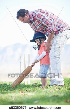 Father and son playing cricket View Large Photo Image Stock Photograph - Father and son playing cricket. Fotosearch