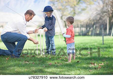 Father and sons preparing stumps for cricket View Large Photo Image Stock Image - Father and sons preparing stumps for cricket. Fotosearch