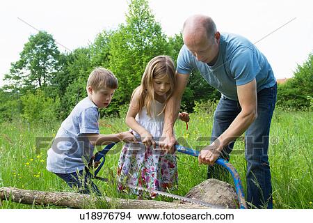 Picture - Father and two children learning to use hacksaw. Fotosearch