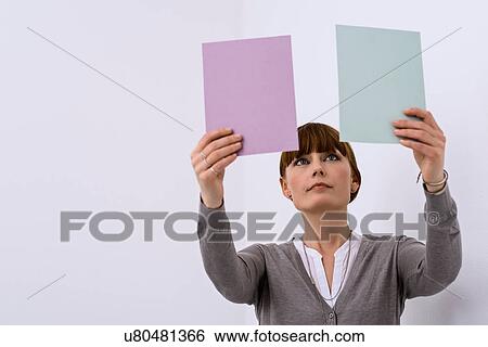 Stock Photograph - Female designer comparing color samples. Fotosearch