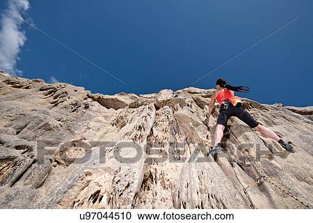 Female rock climber nearing cliff top View Large Photo Image Stock Image - Female rock climber nearing cliff top. Fotosearch