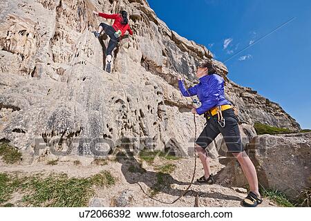 Female rock climbers near cliff base View Large Photo Image Stock Image - Female rock climbers near cliff base. Fotosearch