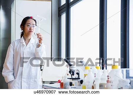 Female scientist examining glass tubes View Large Photo Image Stock Photo - Female scientist examining glass tubes. Fotosearch