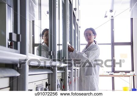 Female scientist using lab machinery View Large Photo Image Stock Photograph - Female scientist using lab machinery. Fotosearch