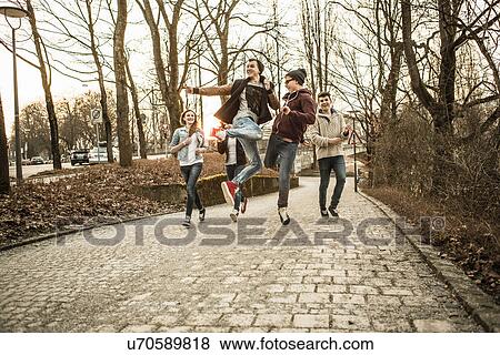 Five teenagers fooling around in park View Large Photo Image Stock Photo - Five teenagers fooling around in park. Fotosearch